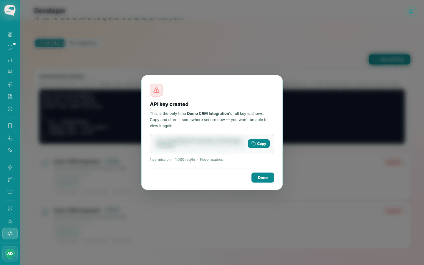 API key created dialog warning that the full key is shown only once, with a Copy button; the key itself is blurred